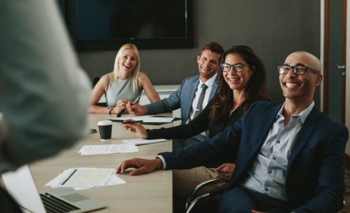 Business people smiling during meeting in board room